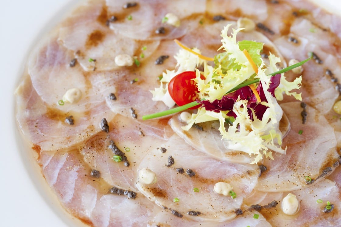 Carpaccio is distinguished by paper-thin pieces of meat, traditionally arranged in concentric circles