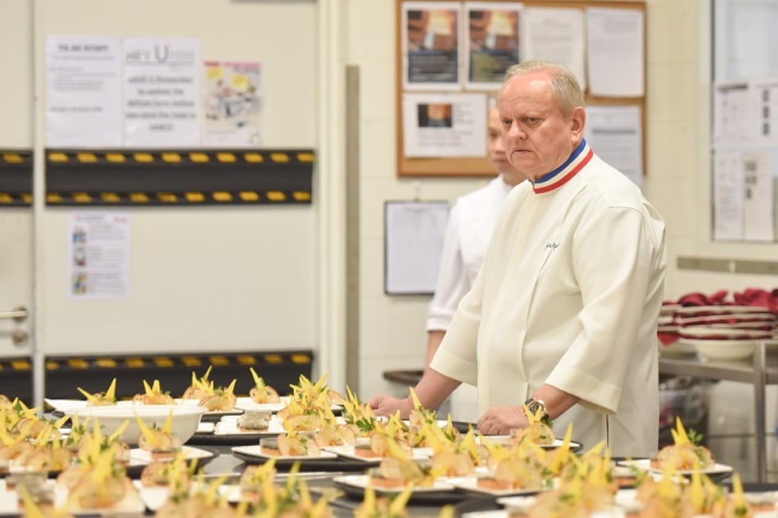 Chef Joel Robuchon scans through rows of amuse bouche.