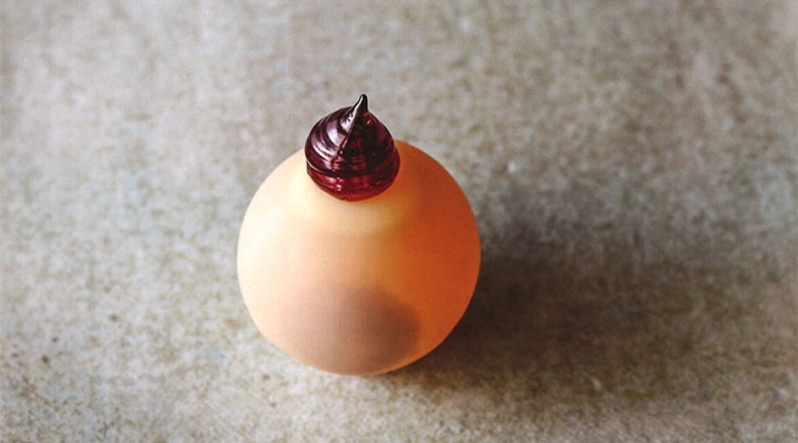 One of Crenn's signature dishes is a play on the traditional Kir aperitif: a white chocolate orb is filled with an apple cider liquid and topped with crème de cassis. Photo by Ed Anderson.  