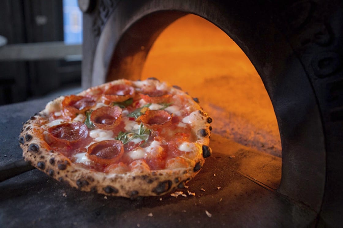 The open space at Del Popolo is centered around a big, blazing oven. (Photo courtesy of Joseph Schell/Del Popolo.)