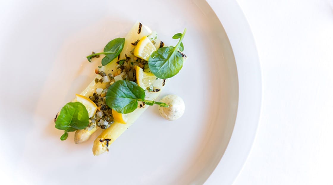 Grilled white asparagus with preserved meyer lemon, watercress and pine nut-caper relish from The French Laundry.