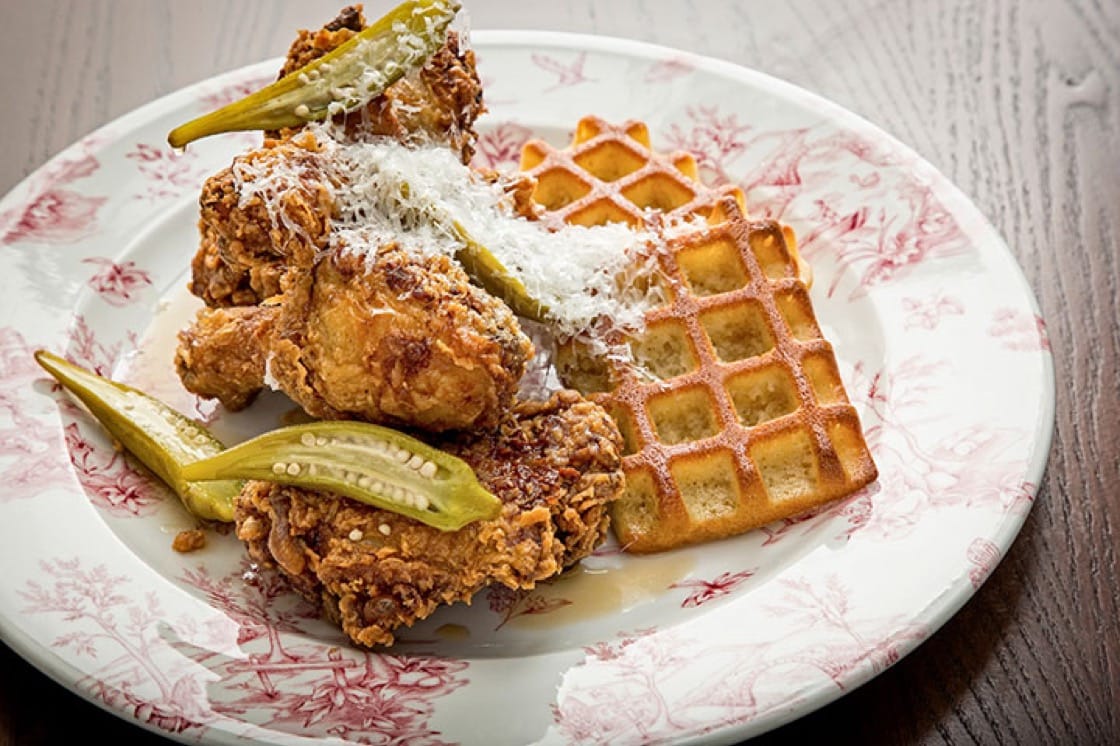 Chicken and waffles with legs and thighs, Bourbon maple syrup, pickled okra and aged Manchego. (Photo courtesy of Succotash.)