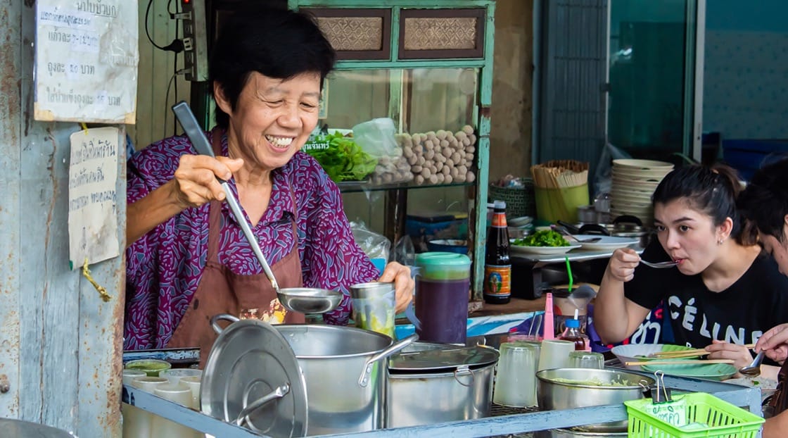 A warm smile in exchange for a cold cup of pennywort juice.