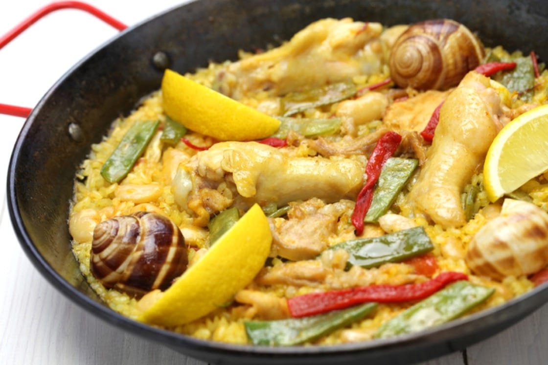 Paella Valenciana is traditionally cooked with what's found in the forest: rabbit and snails.