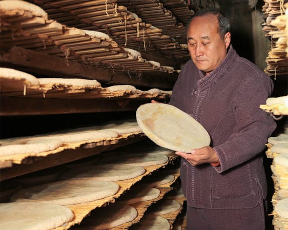 Makgeolli master and CEO of Geumjeong Sanseong Brewery Yoo Cheong-gil in the nuruk fermentation chamber