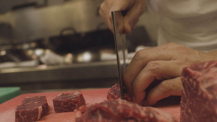 Dicing beef into one-inch cubes is a new attempt for chef Lau.