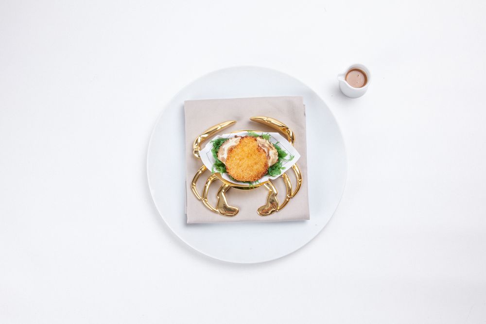 To celebrate its 10th anniversary, TATE launched its Ode to Sauce tasting menu. Its Ode to Crab dish combines parmesan cheese, white sauce and crab meat.