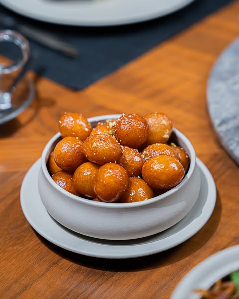 Crispy and golden luqaimat are an addictive favorite in Qatari cuisine. Image credit: Saasna