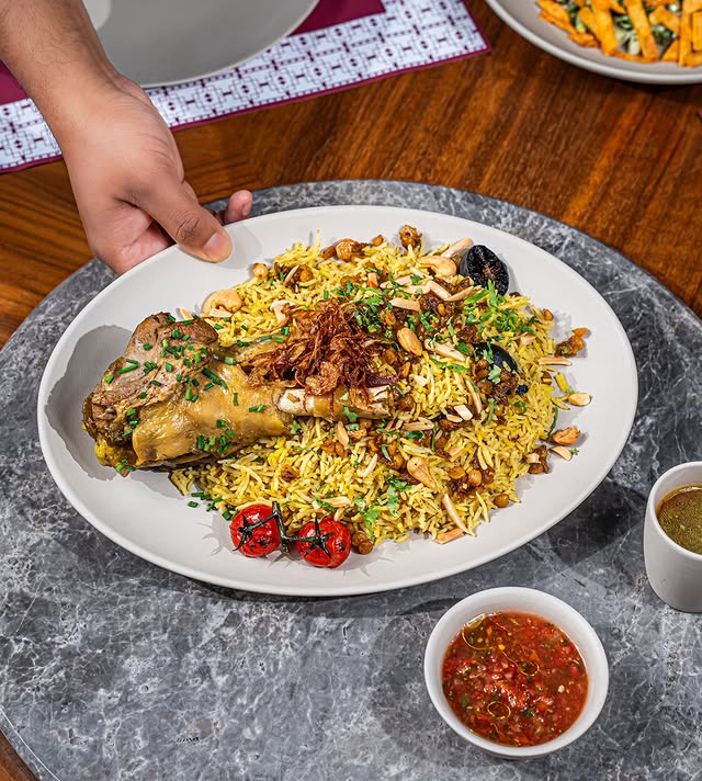 Saasna's machboos served with flavored rice and lamb shank. Image credit: Saasna
