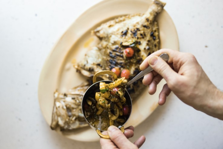 The finishing touches being applied to a fish dish. © Alex Macleod