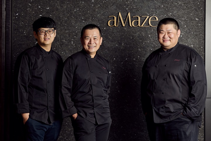 Yang (center) emphasizes that aMaze is far from a solo endeavor, with its creative energy coming from the entire team. On the right is chef Mark Huang, and on the left is sous chef Jack Chou of aMaze. (©aMaze)