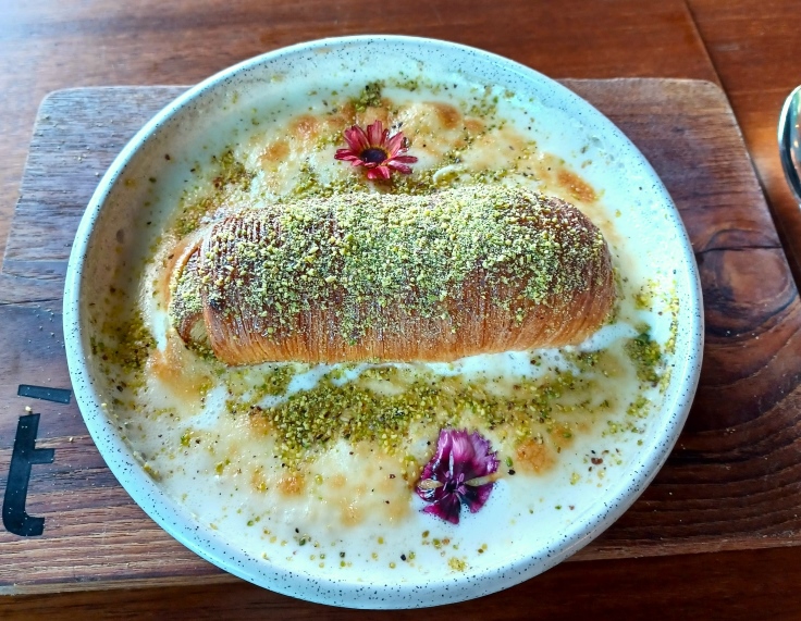 The Um Ali at ťazal is a special milk pudding with a flaky pastry at the center. Image credit: The MICHELIN Guide