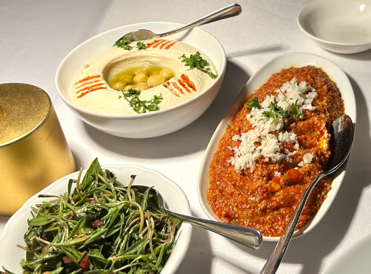 A delightful pairing of creamy hummus and tangy itch salad go perfectly with bread at the start of your meal. Image credit: The MICHELIN Guide