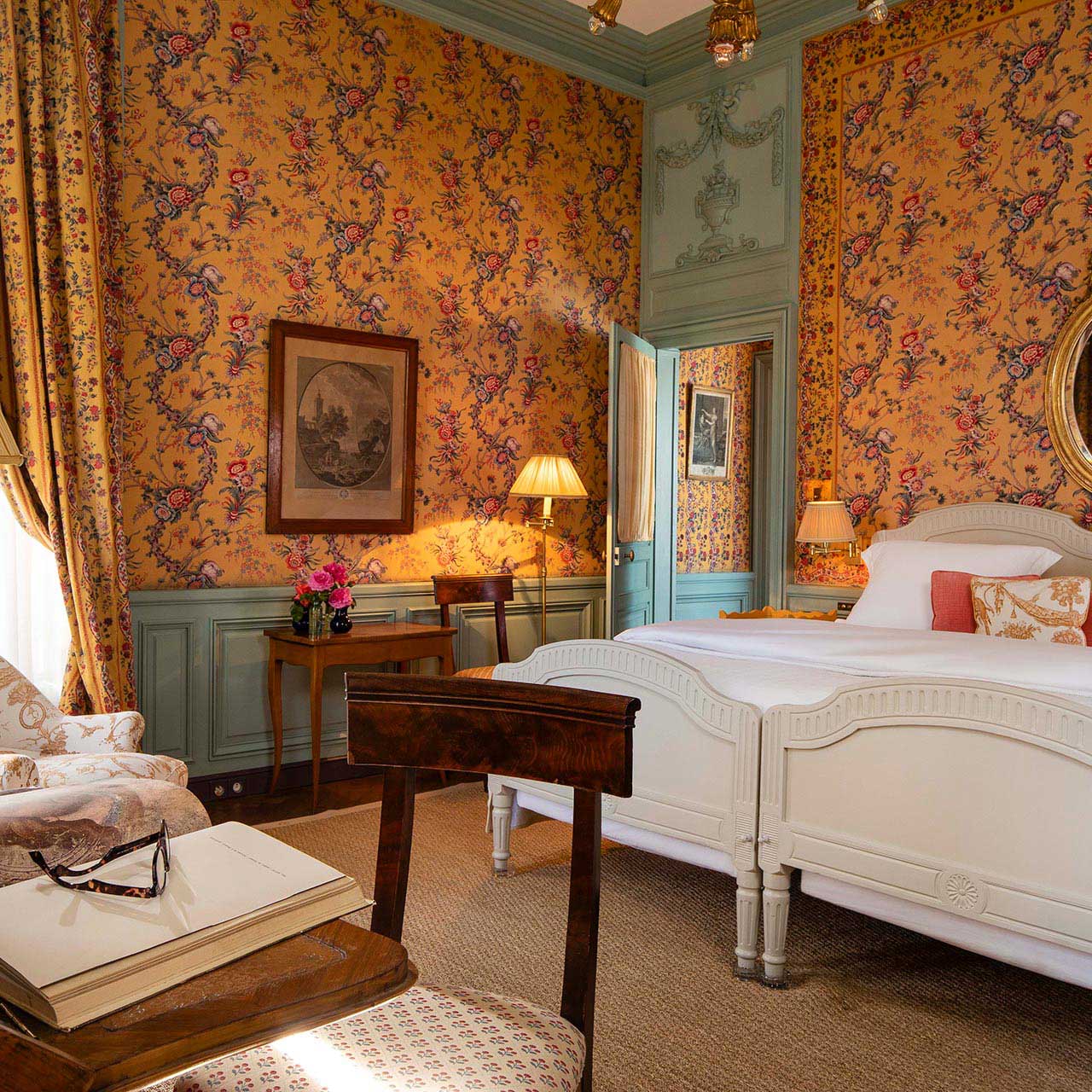 A richly patterned bedroom at the hotel, where antique furnishings and fabrics recall centuries of traditon. © La Mirande
