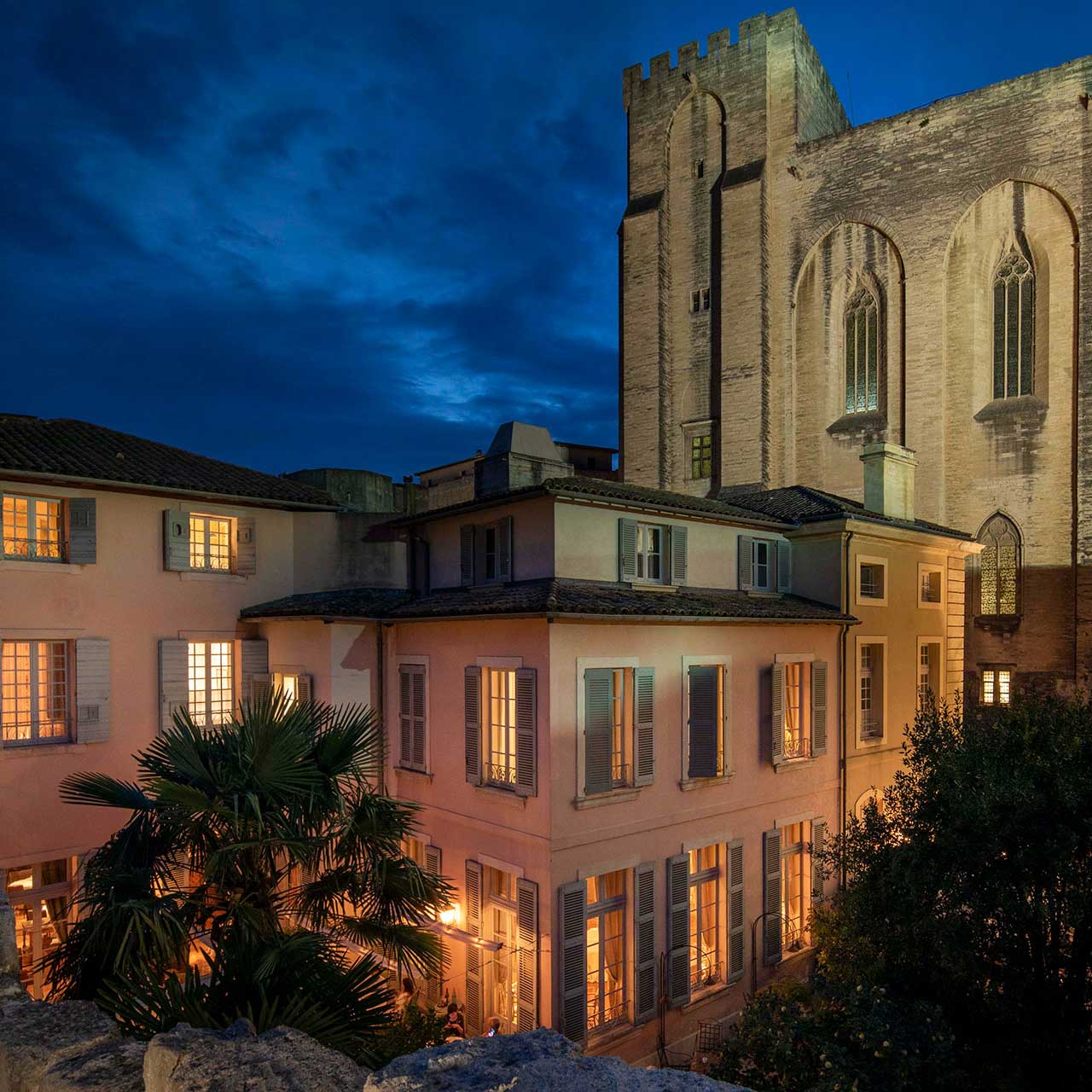 The 17th-century façade of La Mirande, designed by Pierre Mignard, stands beside Avignon’s Palais des Papes. © La Mirande