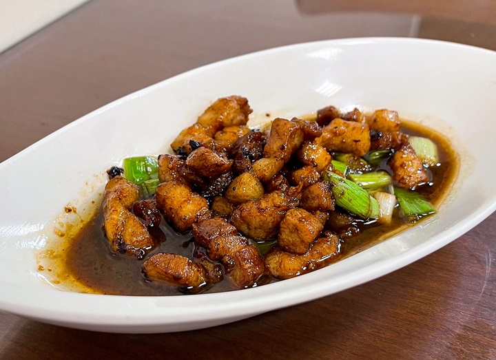 Dishes at Chao Ming, such as the signature stir-fried pork belly with garlic sprouts, deliver a true taste of Taiwanese home cooking. (© MICHELIN) 
