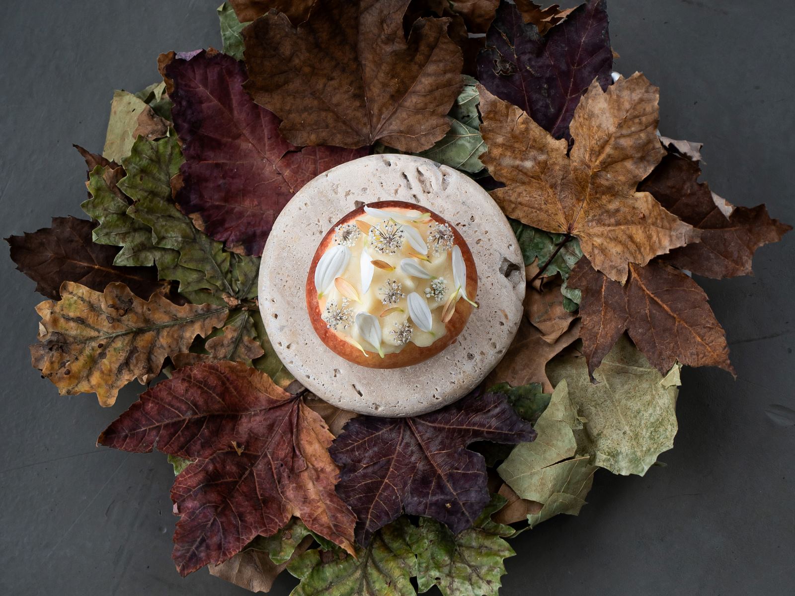   Meana apple from Asturias stuffed with sheep's curd, honey from Kanpezu and corn crumbs, at Islares, a One MICHELIN Star restaurant in Bilbao. © Haydé Negro/Islares