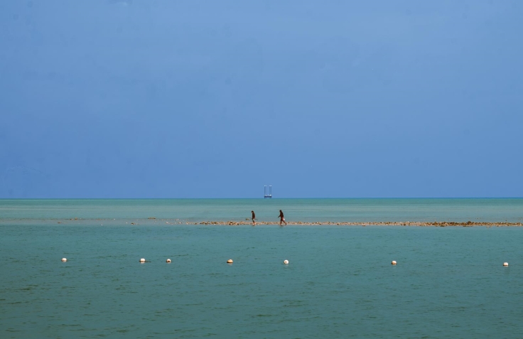 Fishermen setting up their fishing lines on a pier in Doha. © CVI Sea Foods