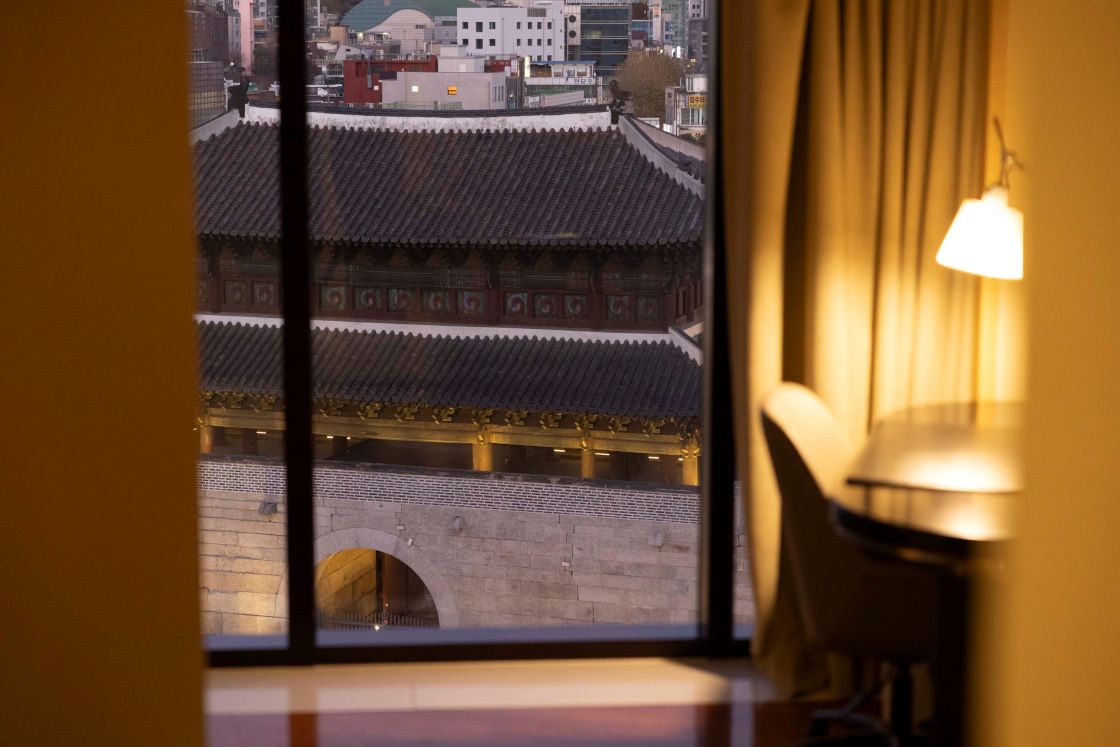 A guest room window frames the iconic Heunginjimun Gate at the JW Marriott Dongdaemun Square. ©JW Marriott Dongdaemun Square