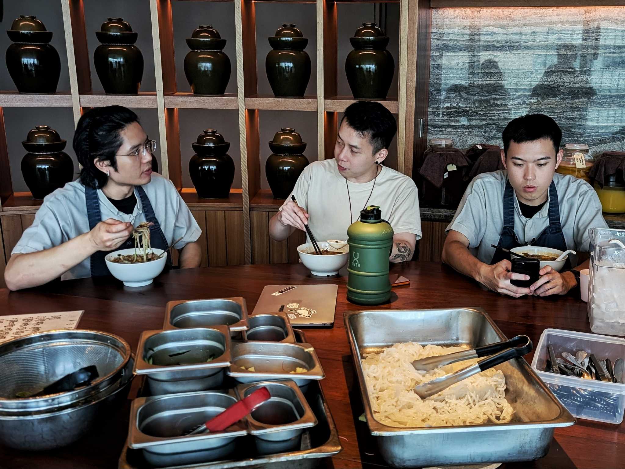 Shafiq Normadi (left), the demi-chef in charge of staff meals at Dewakan, speaking to chef de cuisine Wayne Wong (center). © Ethan Lau