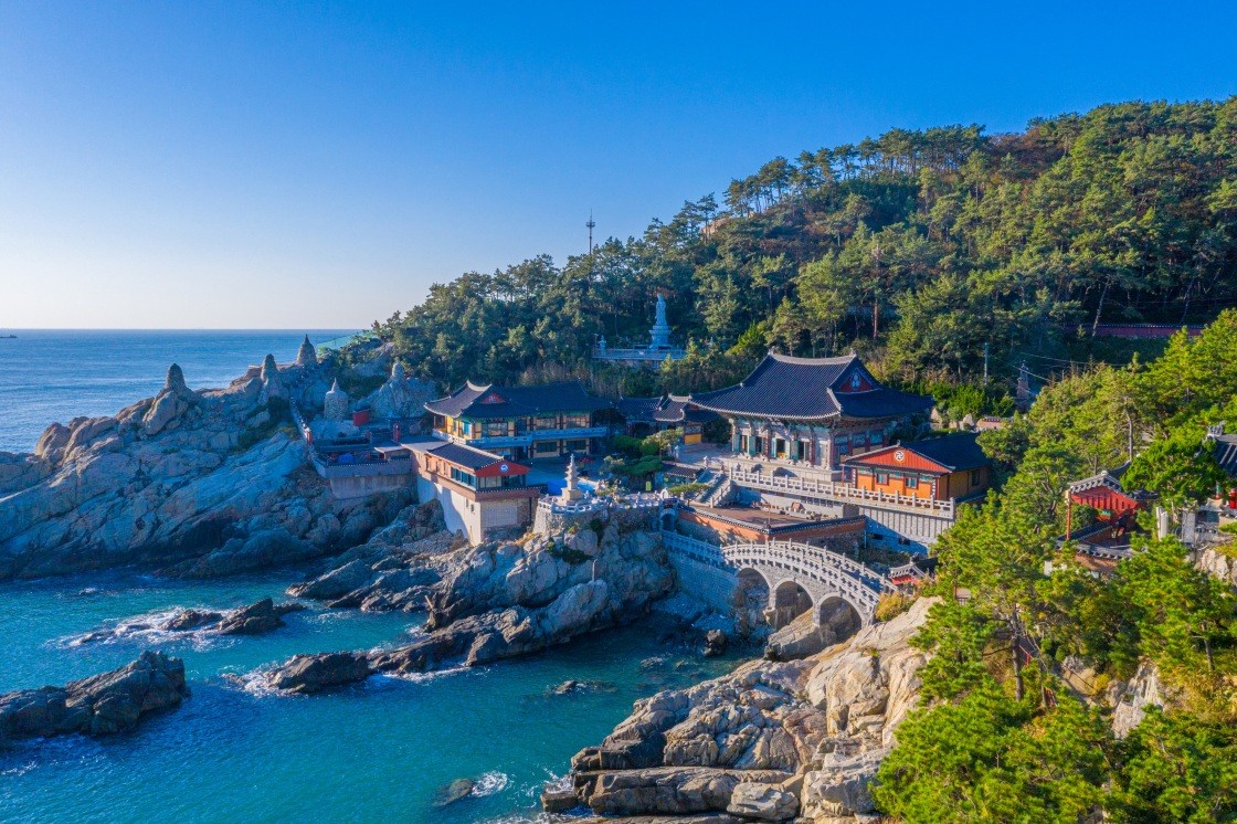 Haedong Yonggungsa Temple stands dramatically against the open sea — one of Korea’s few seaside temples atop rugged black rock. © Trabantos/Shutterstock