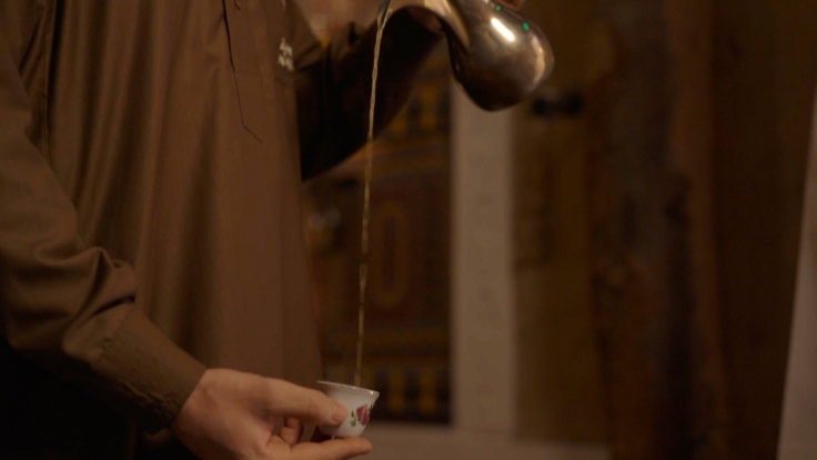 Fragrant gahwa (coffee) is poured in a traditional way in Bib Gourmand Najd Village. © MICHELIN Guide