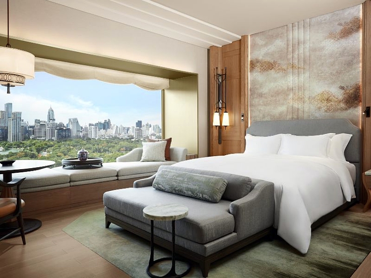 Deluxe King Room, a serene 50-sq-m retreat with sweeping views of Lumpini Park and the city skyline, featuring Thai-inspired design of the new Dusit Thani Bangkok. (© Dusit Thani Bangkok)