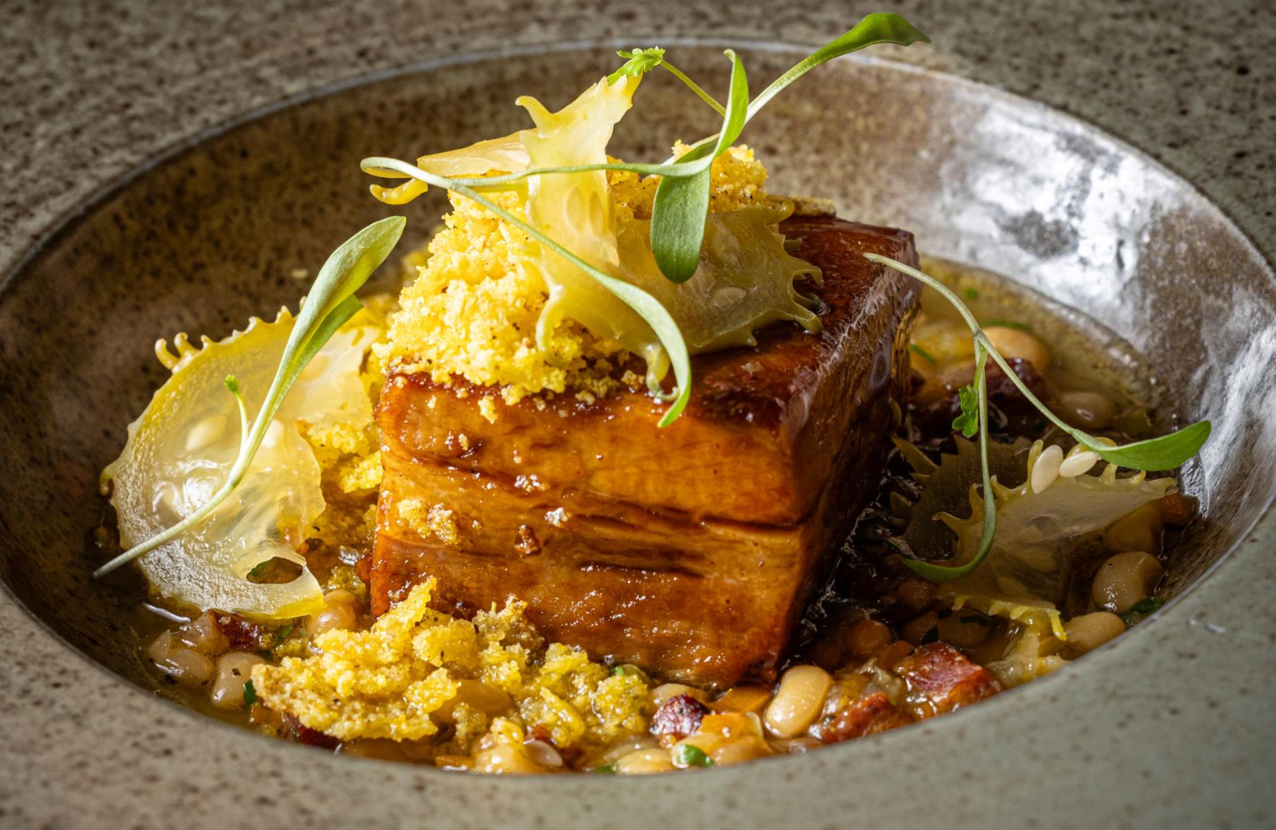 Glazed pork belly with black tucupi, served with feijão-manteiguinha and maxixe, at Clandestina, helmed by Bel Coelho. © Raphael Criscuolo/Clandestina.