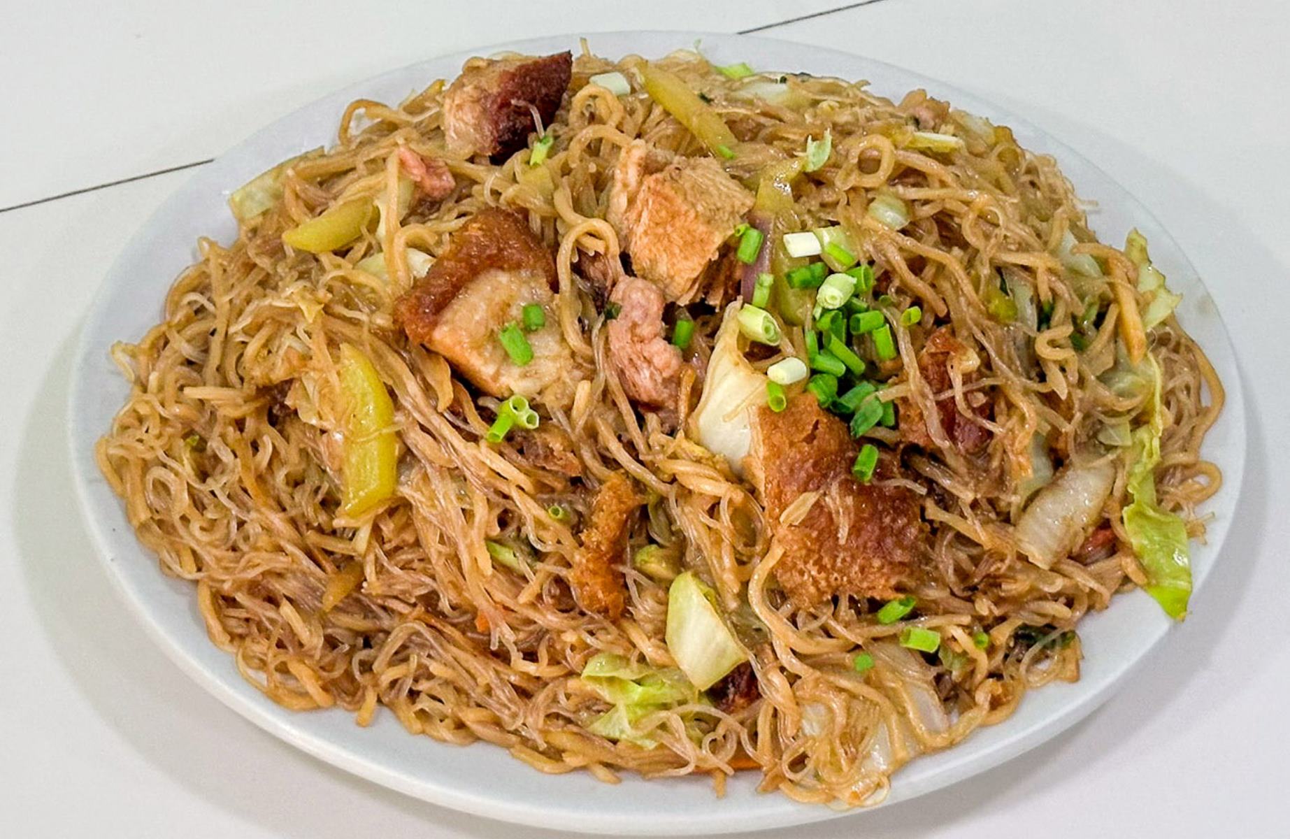 Bihon canton is a classic Manila stir-fry of thin rice and egg noodles mixed with meat, vegetables and light seasonings for a familiar, comforting taste. © Lola Helen
