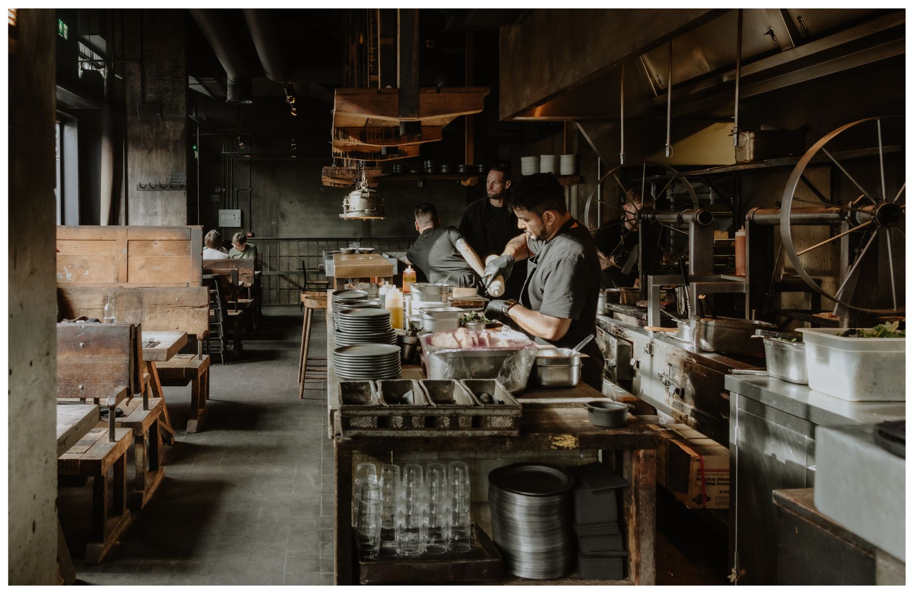 The industrial-inspired kitchen and dining room at Smokestak. © Joanna Yee/The MICHELIN Guide