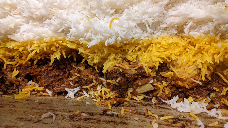 Inside the pot, rice and ingredients cook in layers, with flavors and textures shifting like geological strata. © Biriyani Osawa