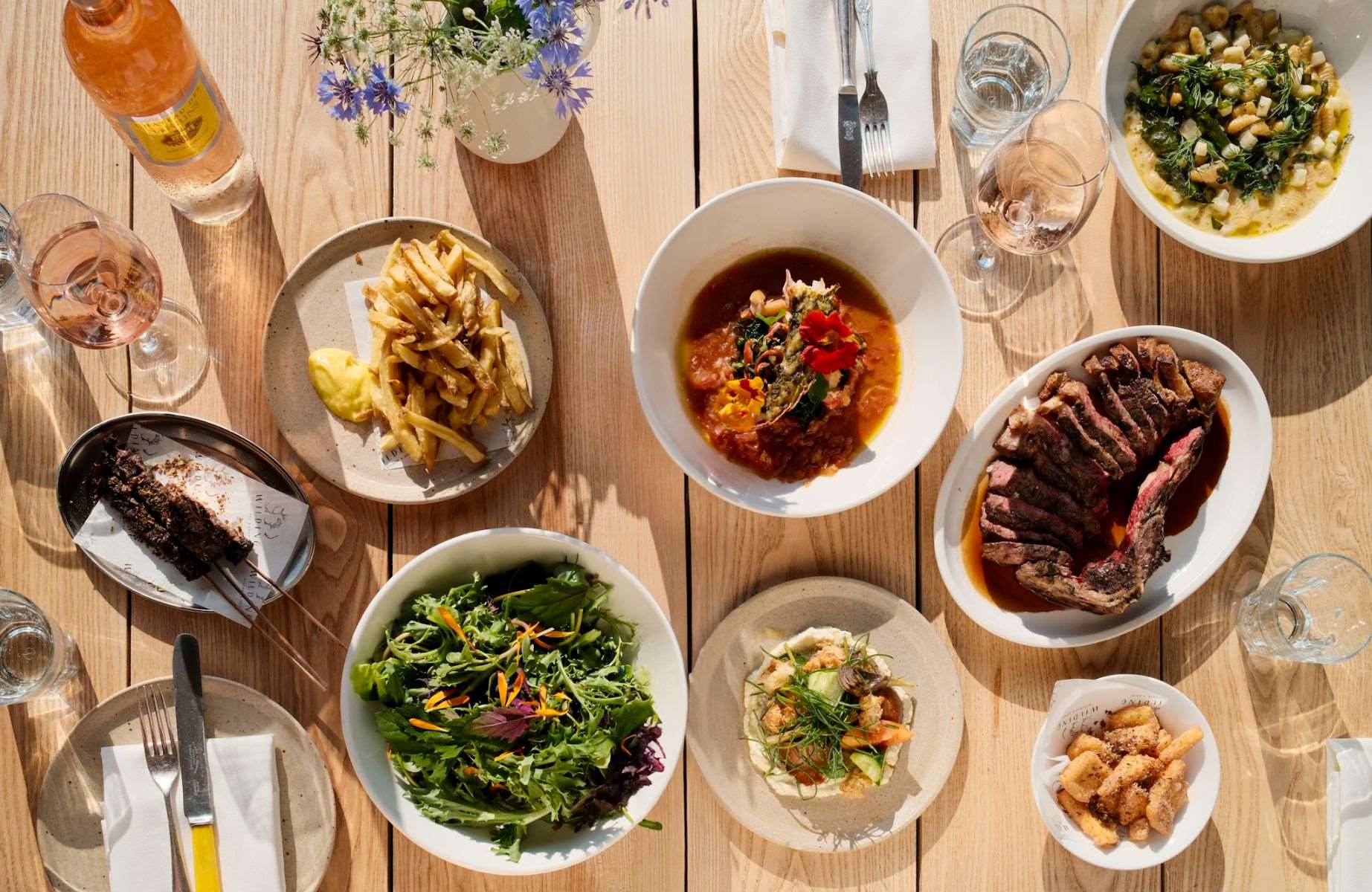 The sun shining on the various responsibly produced dishes at Knepp Wilding Kitchen. © Lia Brazier/Knepp Wilding Kitchen