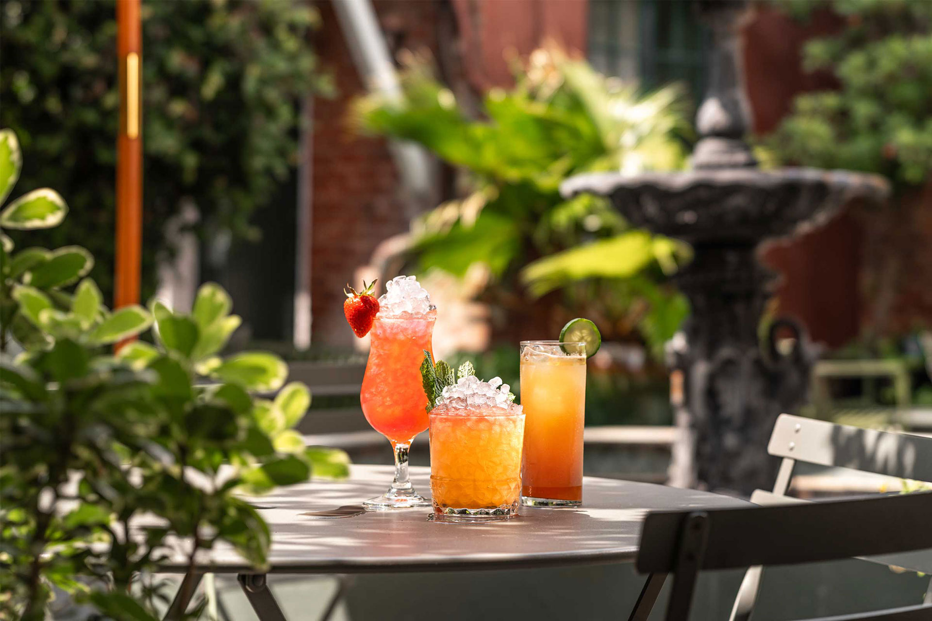 Signature cocktails from Peychaud's in the verdant courtyard. © Ashley Estave/The Celestine