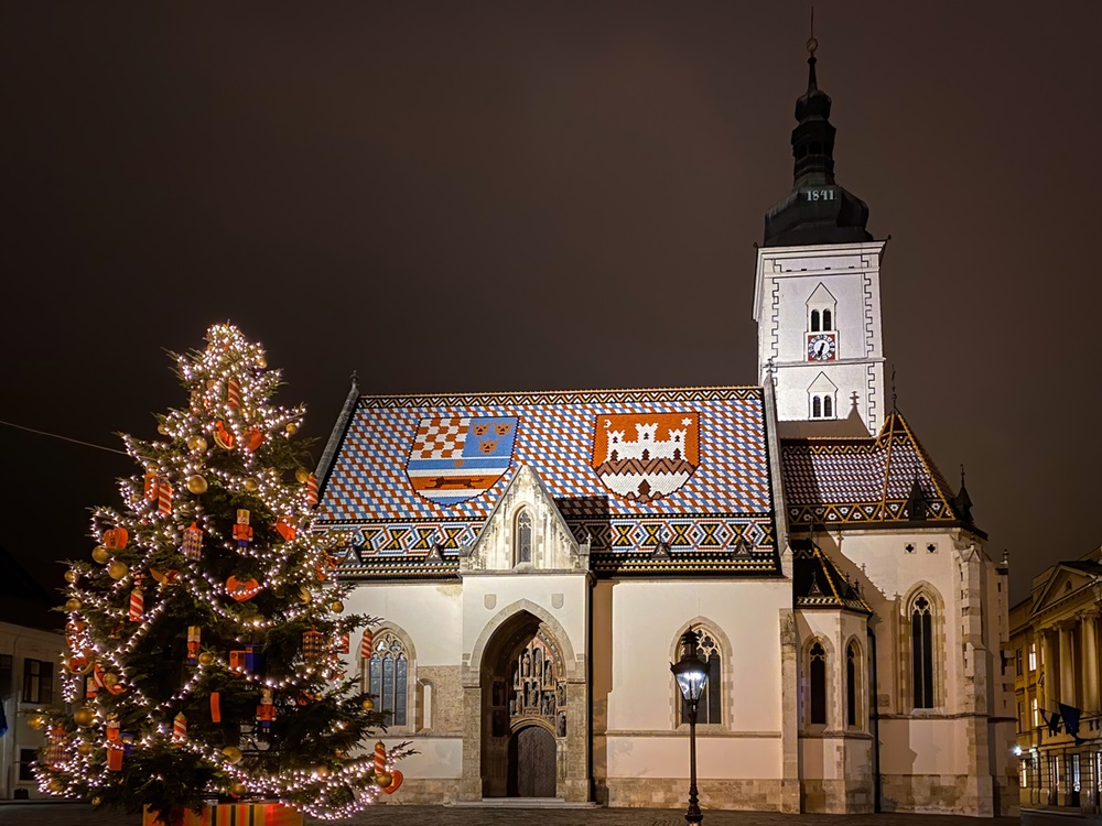 St. Mark's church in Zagreb, Croatia with Christmas tree at night - Emson/iStock