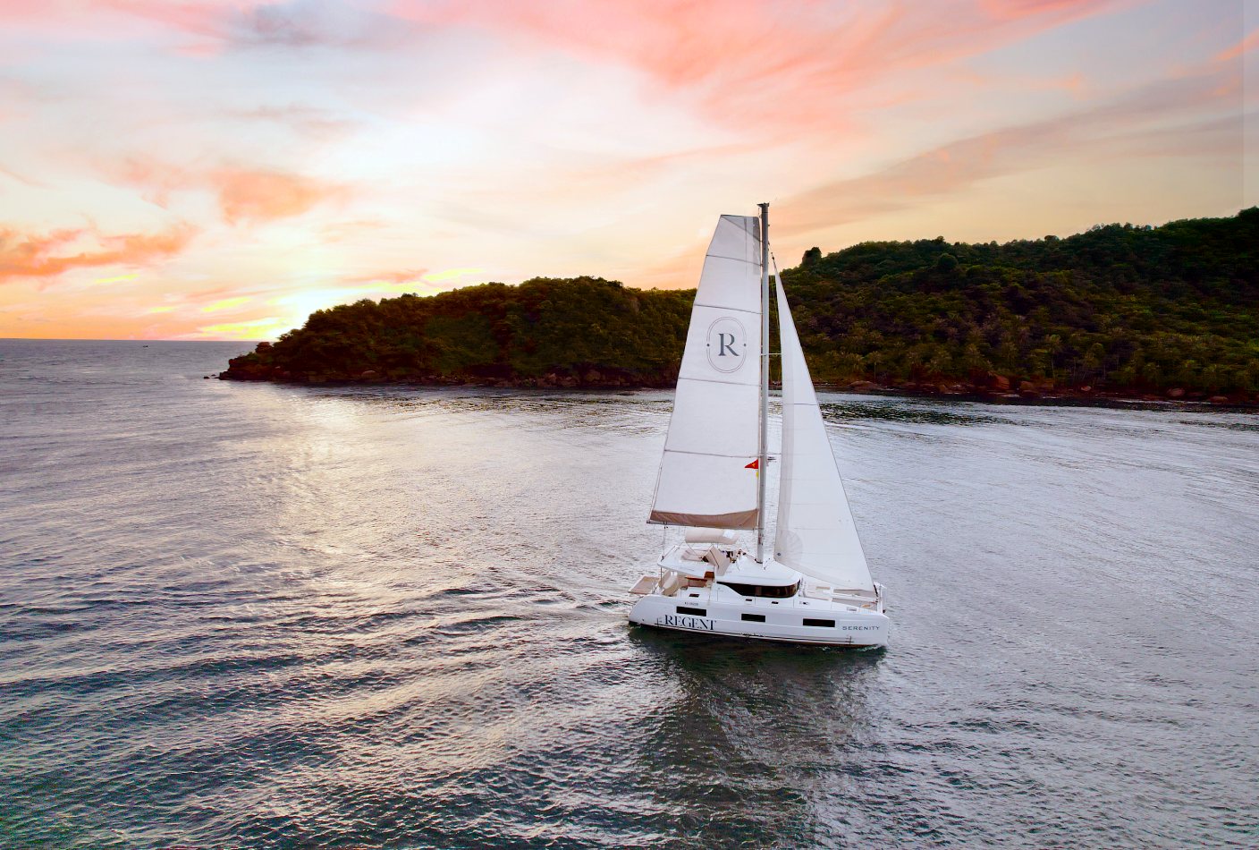 Regent Phu Quoc pairs barefoot beachfront luxury with private catamaran cruises — think paddleboarding, fishing, Champagne and cinematic island sunsets. © Regent Phu Quoc