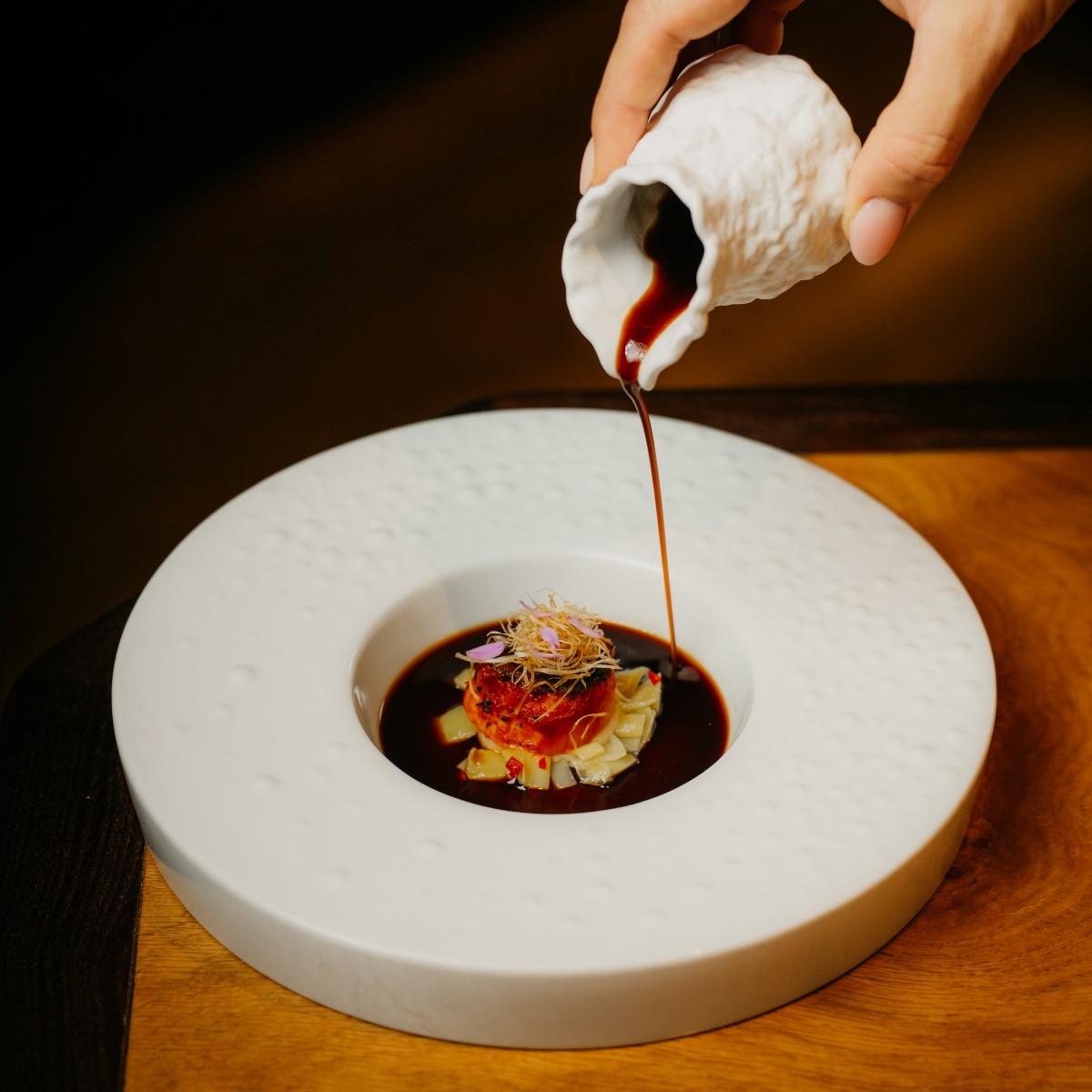 Scallop, leek, and pepper: A dish showcasing diverse textures from Porto’s dop restaurant, recently reimagined by chef Rui Paula. © Robin Barbosa/dop