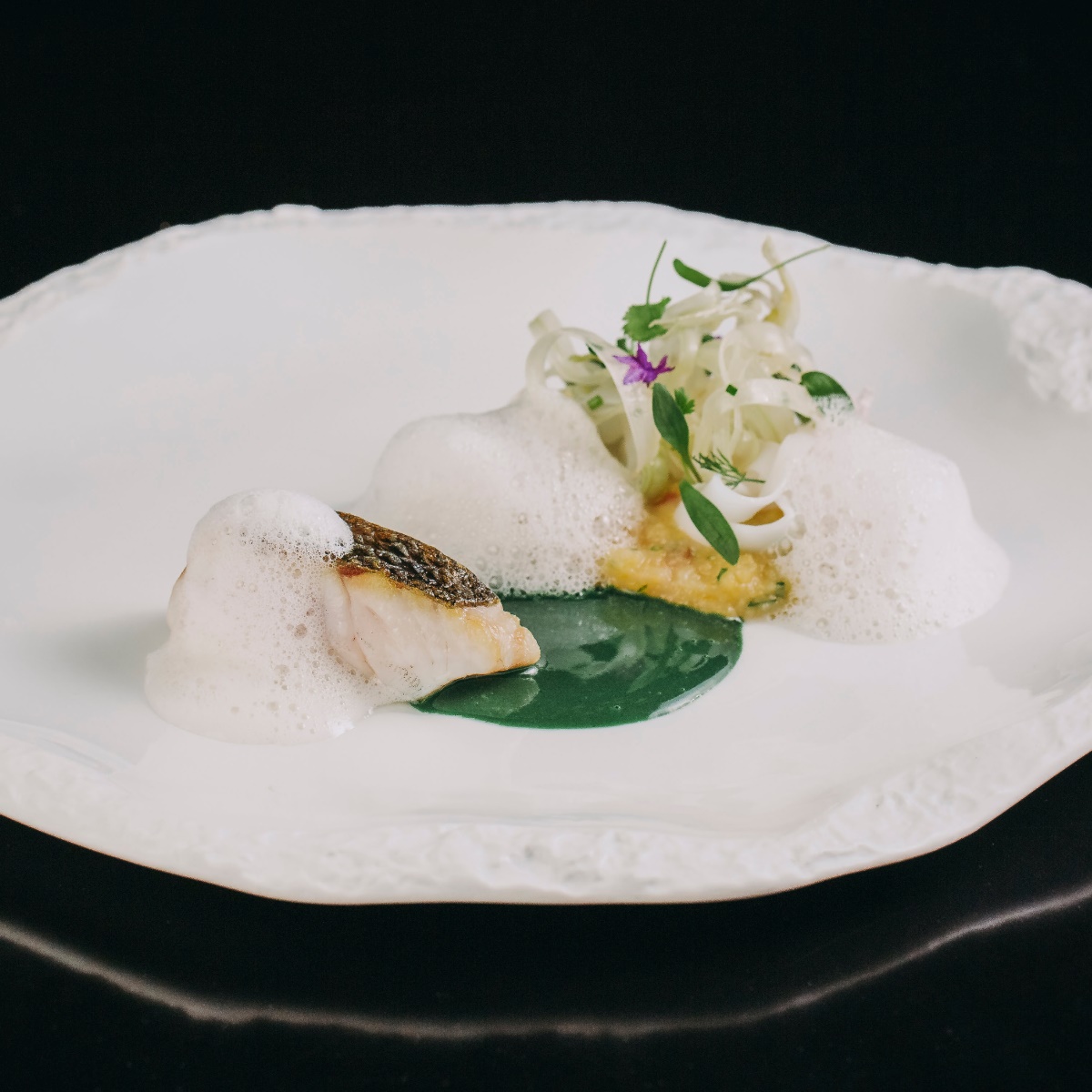 Line-caught sea bass, squid, corn porridge, fennel and plankton: A harmonious and meticulously crafted dish by Chef Angélica Salvador of Porto’s newly Starred restaurant In Diferente. © Luis Ferraz/In Diferente 