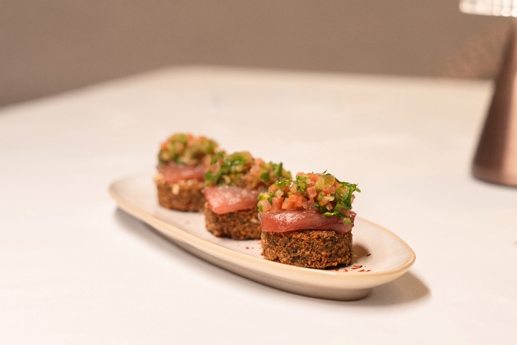 Thinly sliced tuna is carefully placed on top of falafel bites. © Mansour Abdullah AlJaafari/Michelin