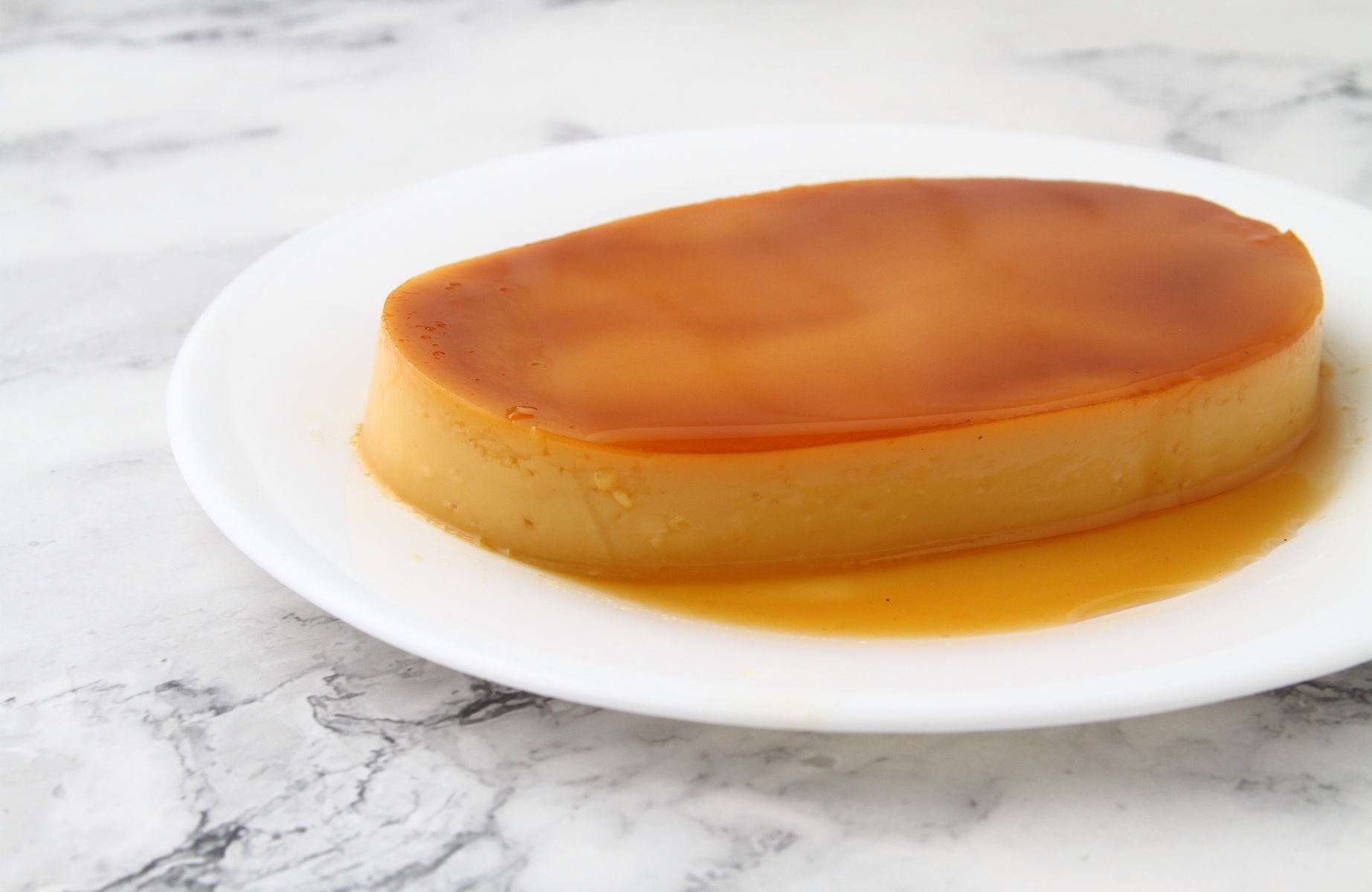 Leche flan is a custard made from leftover egg yolks, enriched with carabao milk and steamed in traditional llaneras. © Jun Pinzon