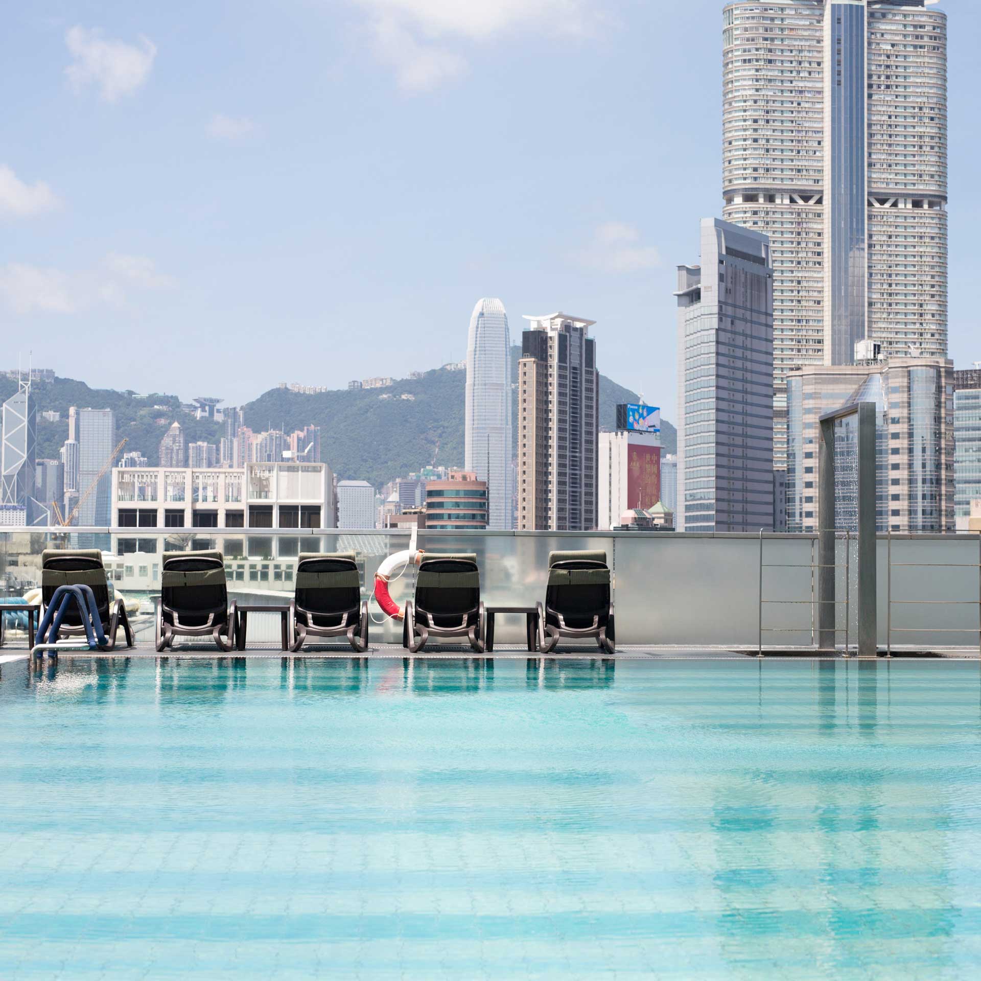 Floor‑to‑ceiling windows frame dramatic Victoria Harbor views in Kowloon. © Hotel ICON Hong Kong