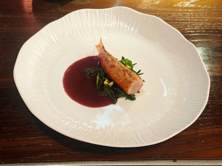 Glazed red mullet from Brittany that is fully deboned, shaped into a neat cylinder, and grilled over charcoal.© MICHELIN
