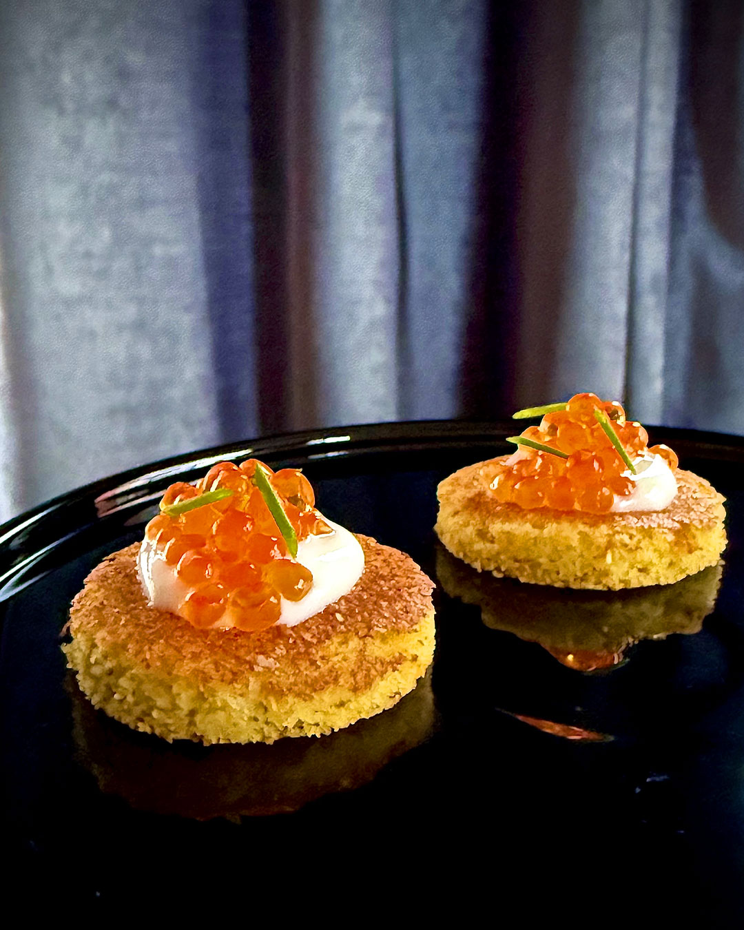 Hoecakes topped with trout roe caviar. © Joseph Lenn/J.C. Holdway