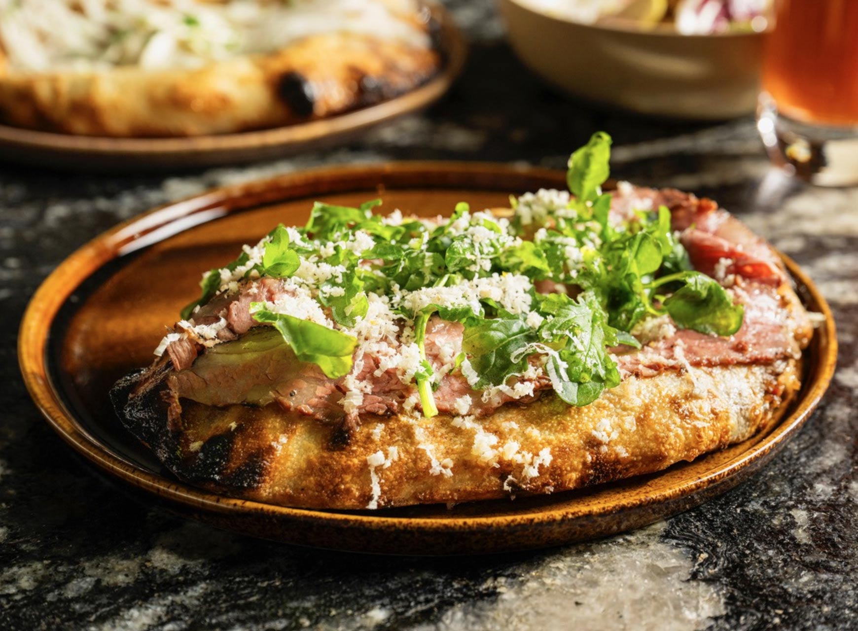 Crown Shy's kulcha with short rib, horseradish and black pepper riffs on the classic New York pastrami sandwich. © Crown Shy