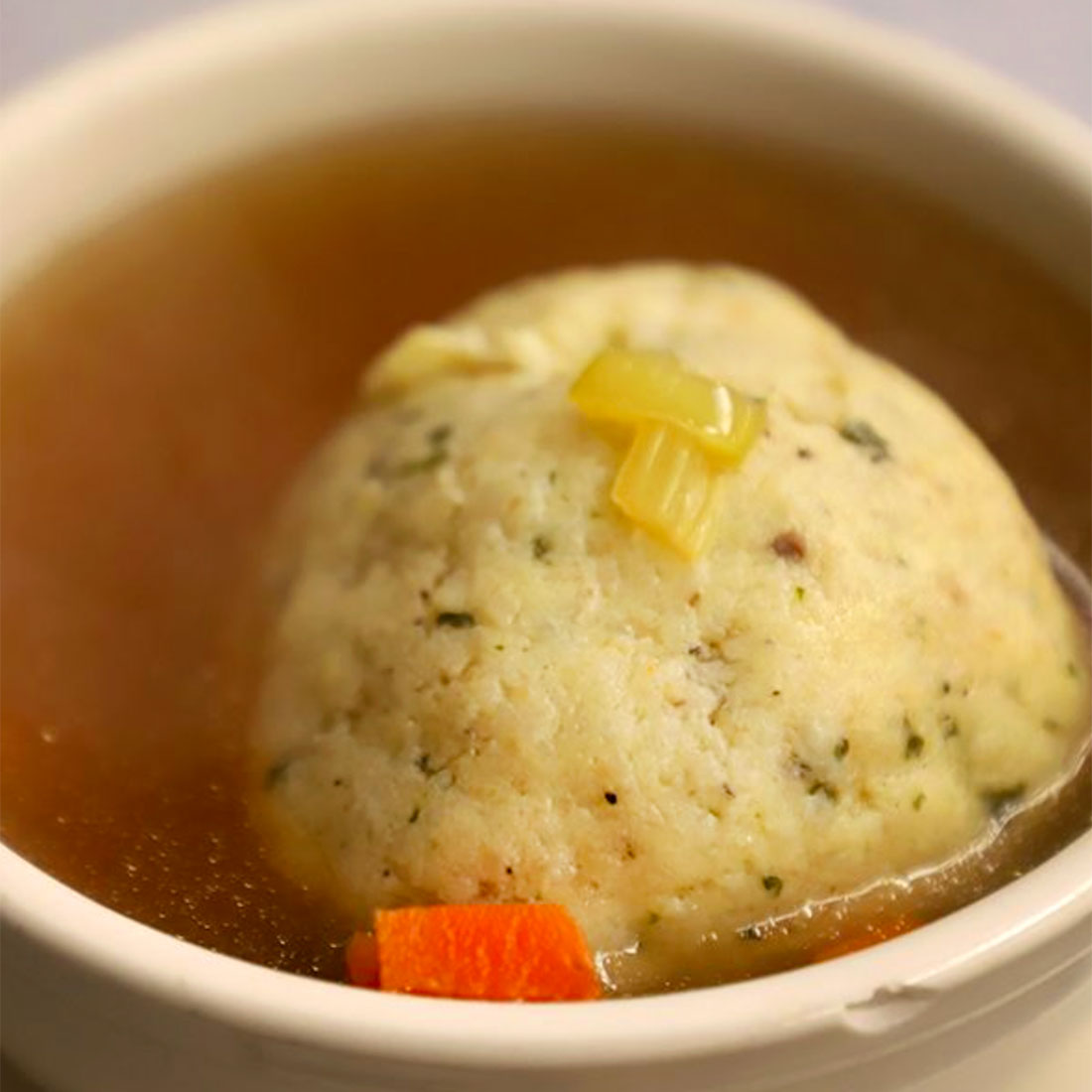 Closeup of matzoh ball and broth. © Katz’s Deli