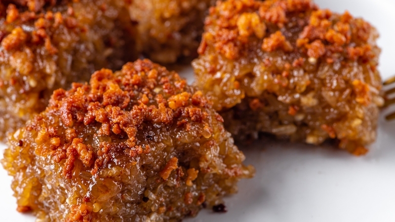 Biko, a sticky rice cake with Hokkien roots, is a symbol of unity and abundance in Filipino culture, served at celebrations or simply enjoyed as a midday snack. © Loy Buckz