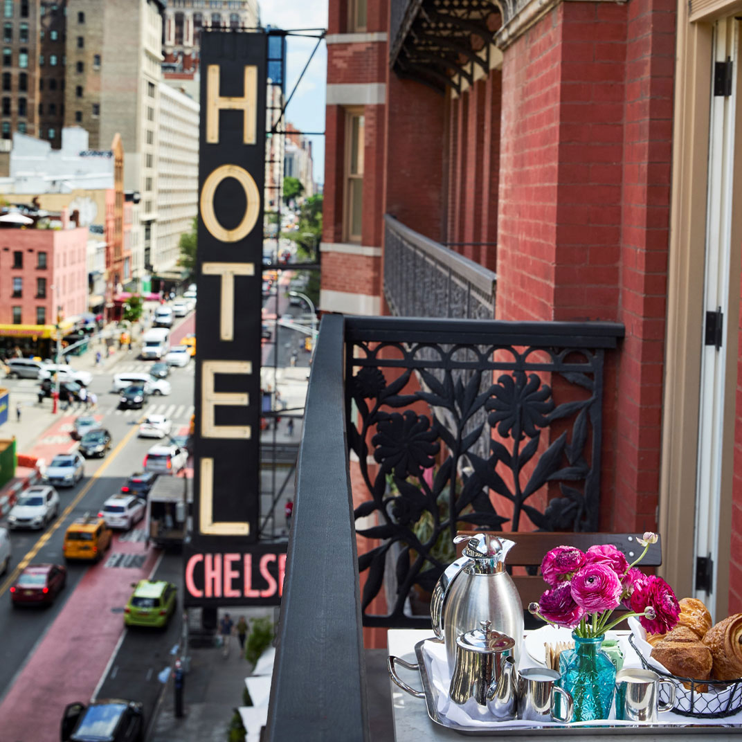 The iconic Hotel Chelsea sign hovers over West 23rd Street. © The Hotel Chelsea