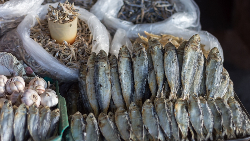 Tinapa and daing reflect the Filipino instinct for preservation — one smoked over hardwood for depth, the other salt-cured and sun-dried — both intensifying the natural flavor of the fish while extending its life. © Filcorz