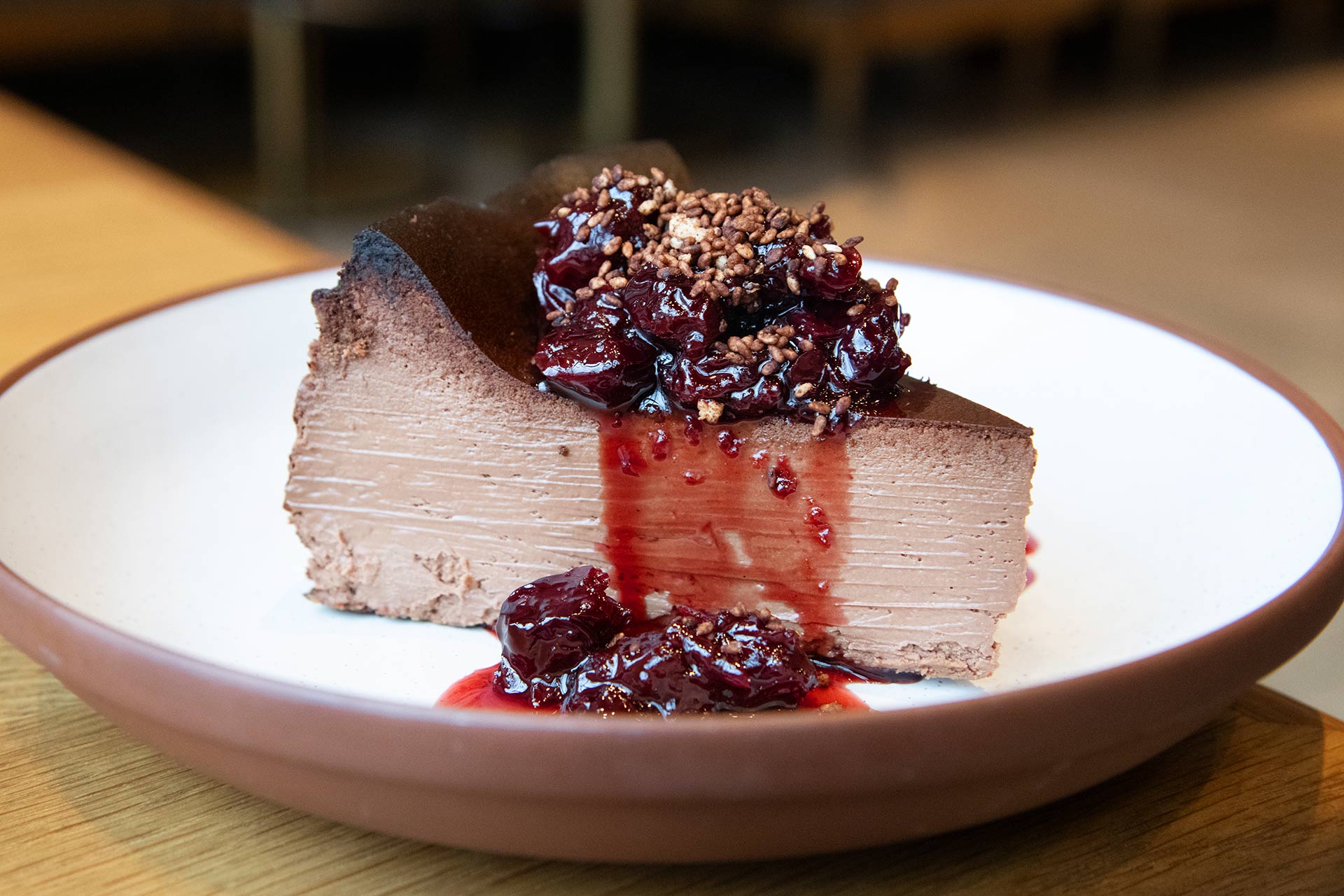 Basque cheesecake with chocolate and compote of citrus-poached cherries. © One Off Hospitality/avec