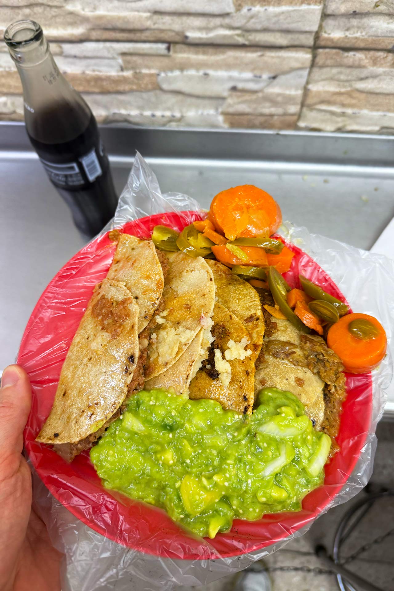Ready to dig in. Tacos come stuffed with mushy chicharrón in a red or green salsa, refried beans or a smooth potato purée. A plate of one of each, alongside a glass-bottle Coke, runs just 65 pesos, or a bit less than four U.S. dollars.© David Shortell/MICHELIN
