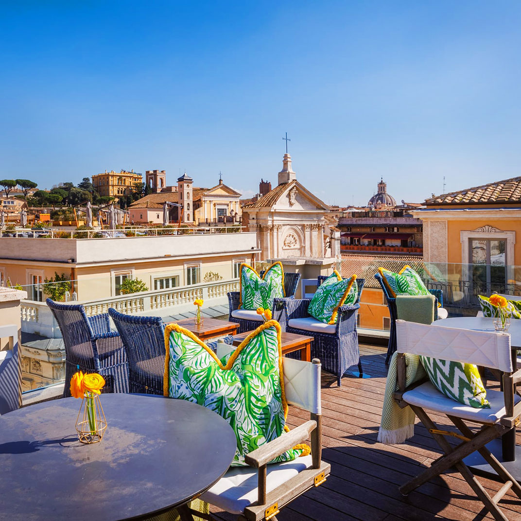 Jim's Bar, with rooftop views of Rome in the background. © Singer Palace Hotel